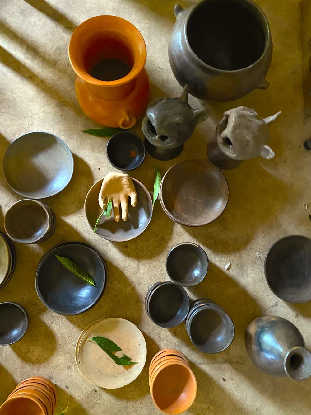 Finished clay pieces drying after a workshop